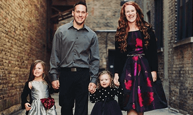 The Ledvinas, an Ronald McDonald House family, posed holding hands in a picturesque brick-lined alley